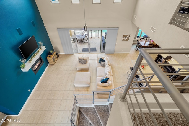 interior space featuring a high ceiling and tile patterned floors