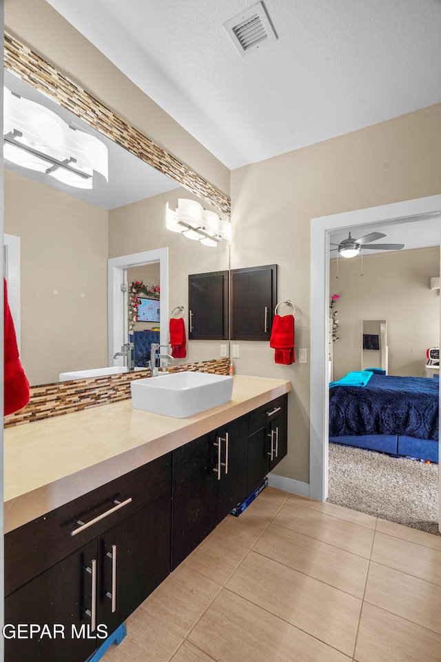 bathroom with vanity, a textured ceiling, tile patterned floors, and ceiling fan