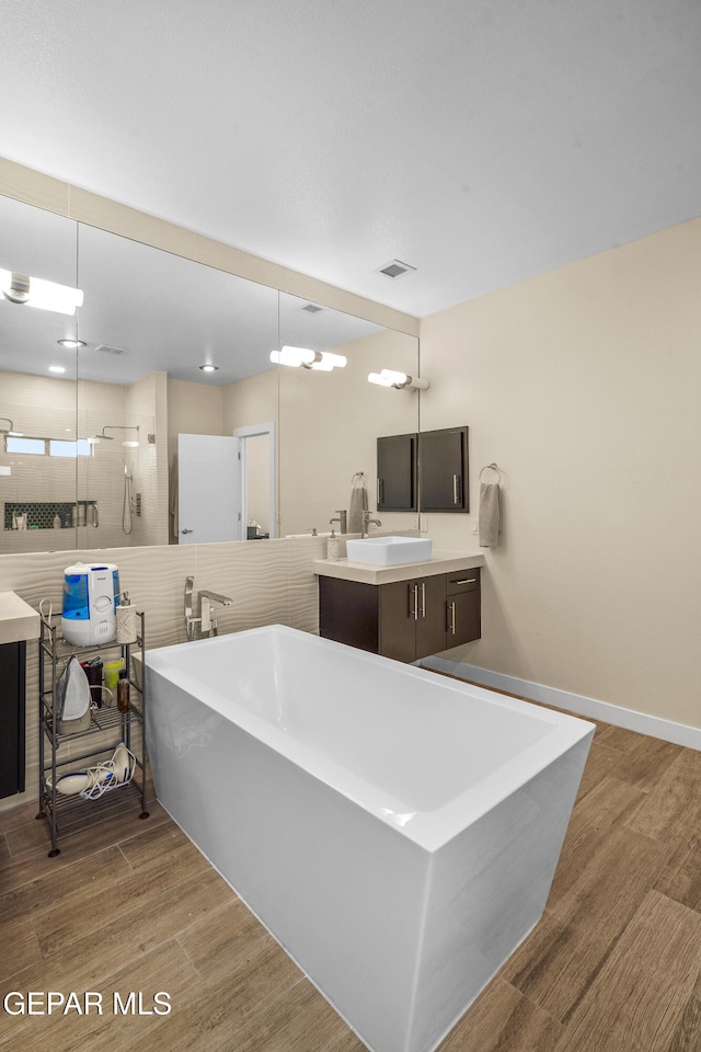 bathroom featuring tile walls, shower with separate bathtub, vanity, and hardwood / wood-style flooring