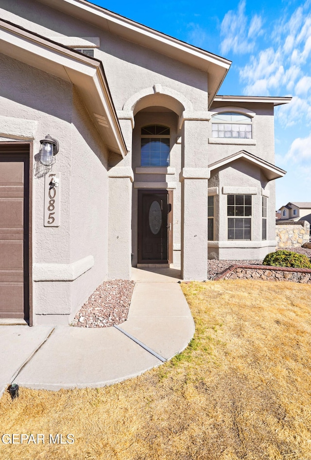 property entrance with a yard