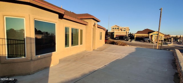 view of side of home with a patio