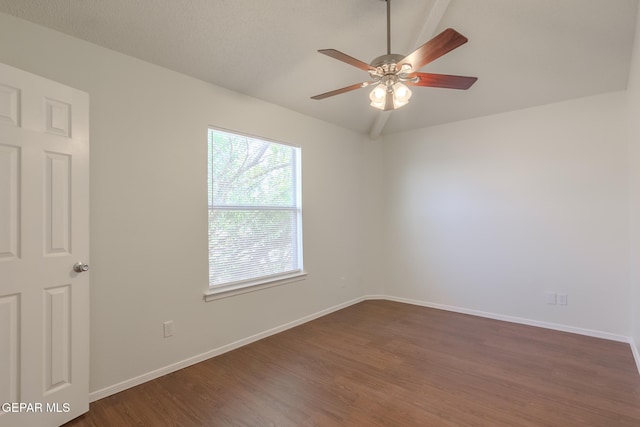 empty room featuring ceiling fan, dark hardwood / wood-style flooring, and vaulted ceiling