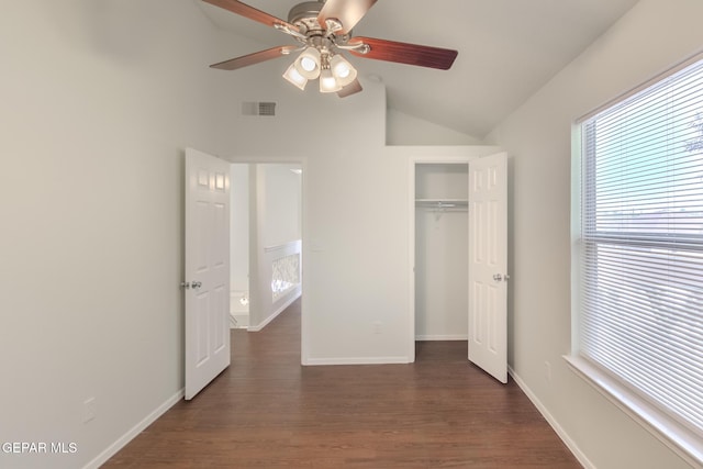 unfurnished bedroom with a closet, dark hardwood / wood-style floors, vaulted ceiling, and ceiling fan