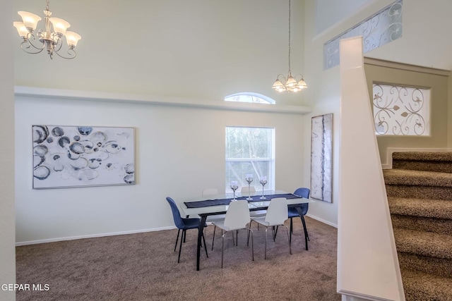 dining area featuring carpet flooring, a high ceiling, and a chandelier