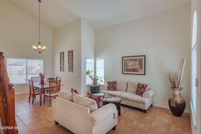 living room featuring a wealth of natural light, an inviting chandelier, and high vaulted ceiling