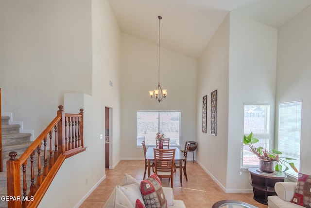 dining space featuring plenty of natural light, light tile patterned floors, high vaulted ceiling, and a notable chandelier