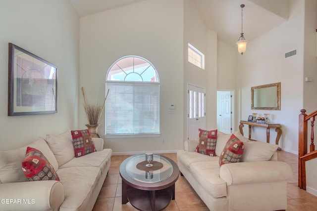 tiled living room with high vaulted ceiling