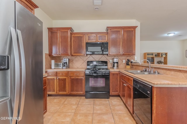 kitchen with black appliances, light tile patterned flooring, decorative backsplash, sink, and kitchen peninsula