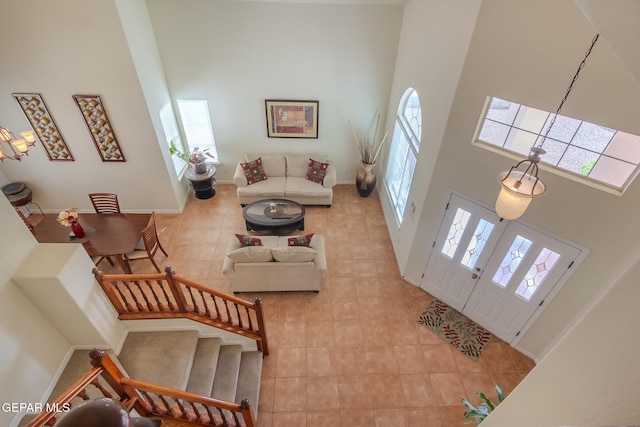 tiled foyer featuring a towering ceiling