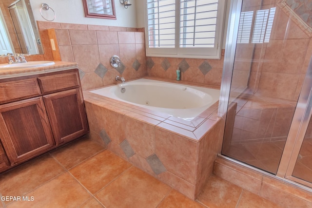 bathroom featuring tile patterned flooring, vanity, and separate shower and tub