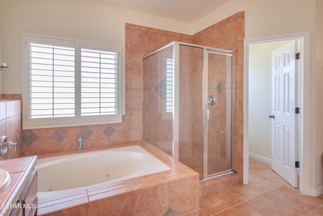 bathroom featuring tile patterned flooring, plenty of natural light, vanity, and plus walk in shower