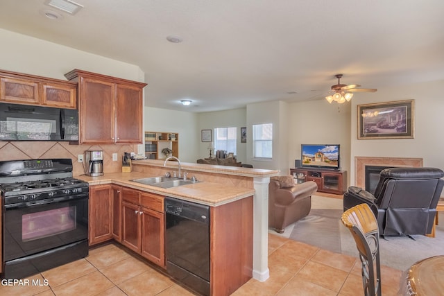 kitchen featuring black appliances, tasteful backsplash, light tile patterned floors, kitchen peninsula, and ceiling fan