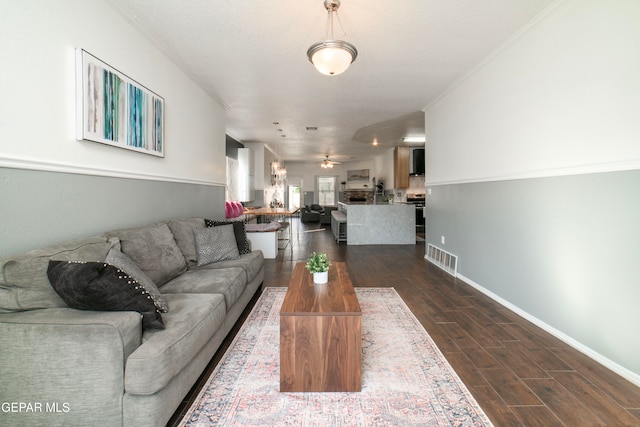 living room featuring crown molding, dark hardwood / wood-style floors, and ceiling fan