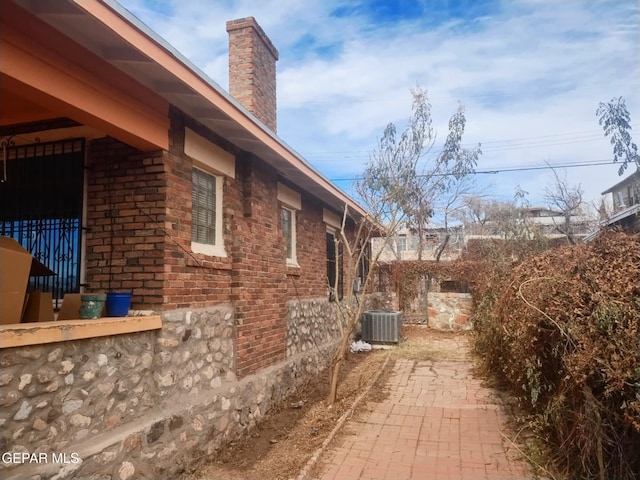 view of side of home featuring central AC