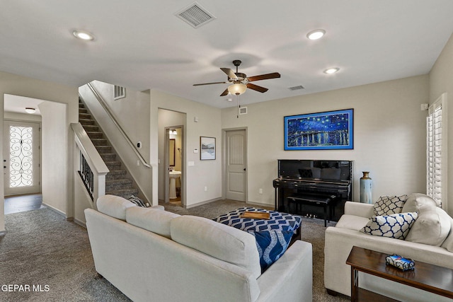 carpeted living room featuring ceiling fan