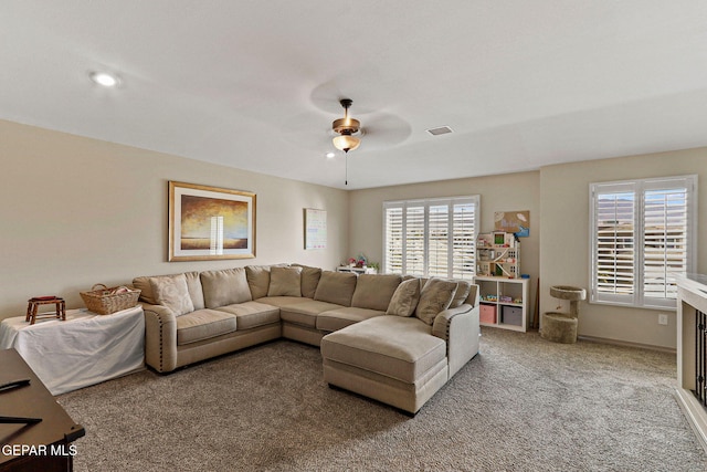 living room with ceiling fan and carpet floors