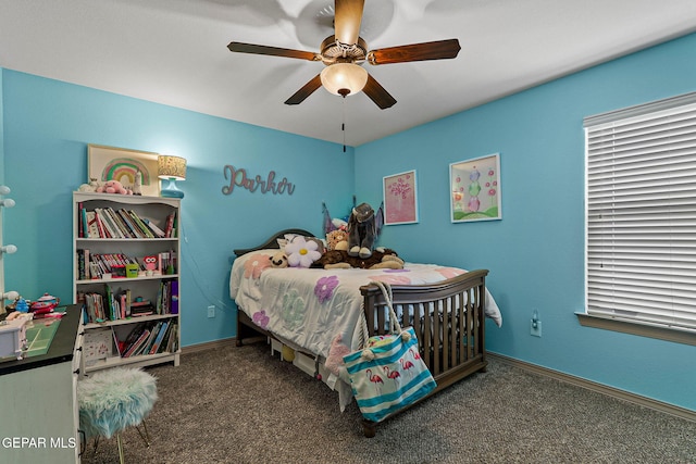 bedroom featuring ceiling fan and dark carpet