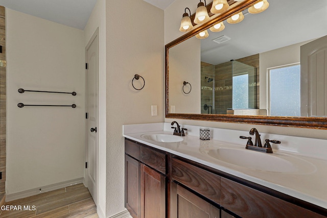 bathroom with walk in shower and vanity