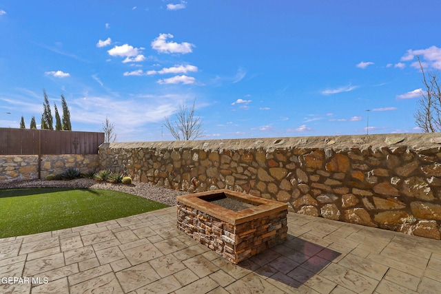 view of patio / terrace featuring an outdoor fire pit