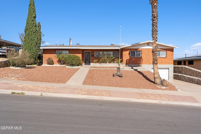 3405 Volcanic Ave, El Paso, TX 79904 - ranch-style home featuring concrete driveway, a garage, and brick siding