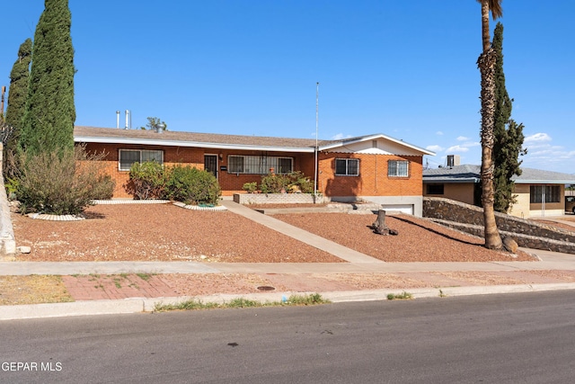 3405 Volcanic Ave, El Paso, TX 79904 - ranch-style home with an attached garage and brick siding