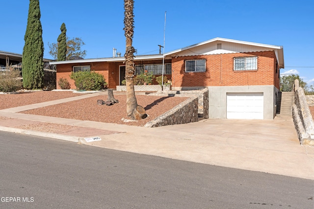 3405 Volcanic Ave, El Paso, TX 79904 - ranch-style home with brick siding, an attached garage, and concrete driveway