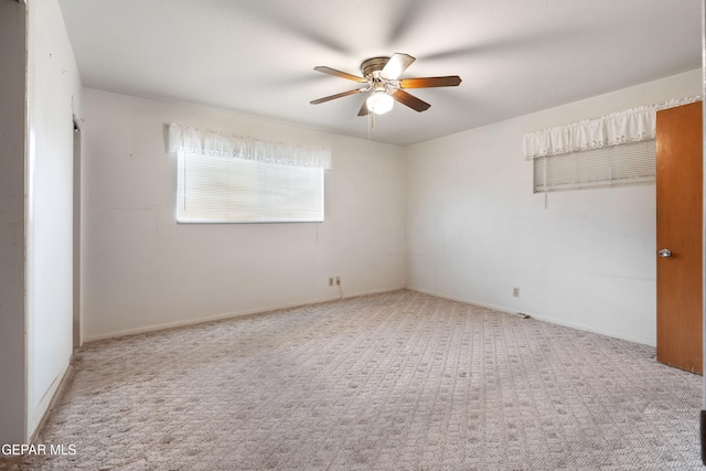 empty room featuring ceiling fan and carpet