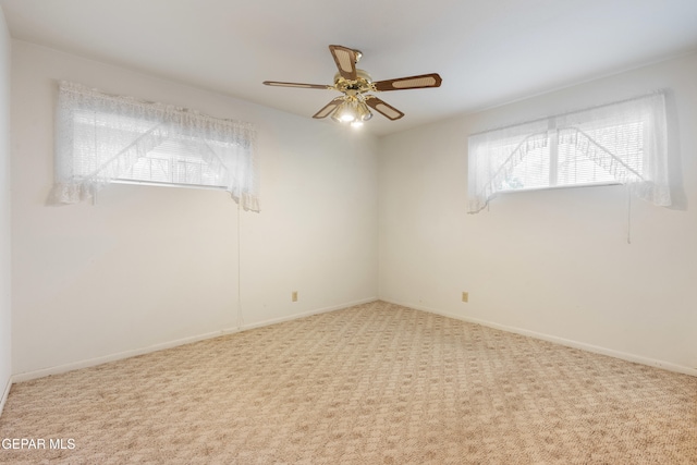 empty room with light colored carpet and ceiling fan