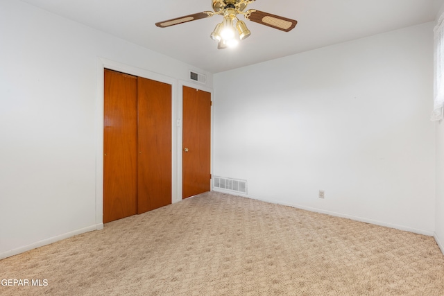 unfurnished bedroom featuring ceiling fan and carpet floors