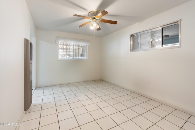 spare room featuring light tile patterned flooring and ceiling fan