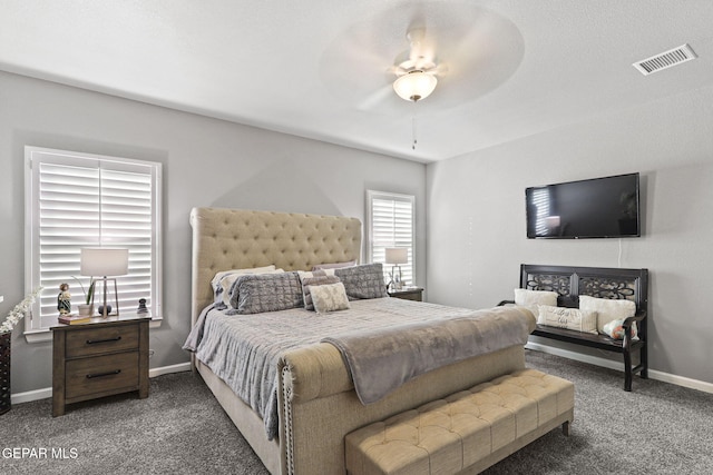 bedroom with ceiling fan and dark carpet