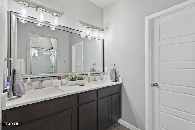 bathroom featuring walk in shower and vanity