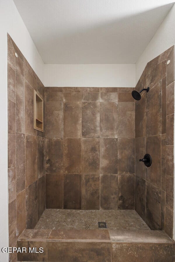 bathroom with a tile shower