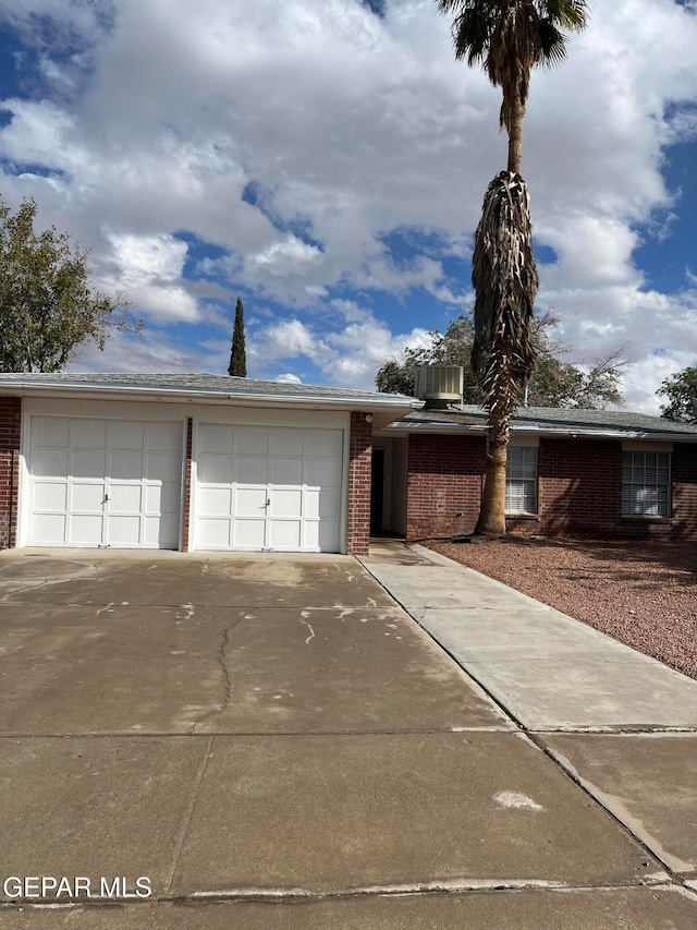 view of front facade with a garage and cooling unit