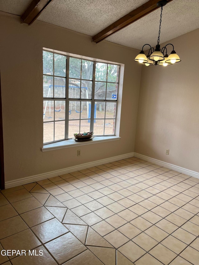 unfurnished dining area with beam ceiling, light tile patterned floors, an inviting chandelier, and a textured ceiling