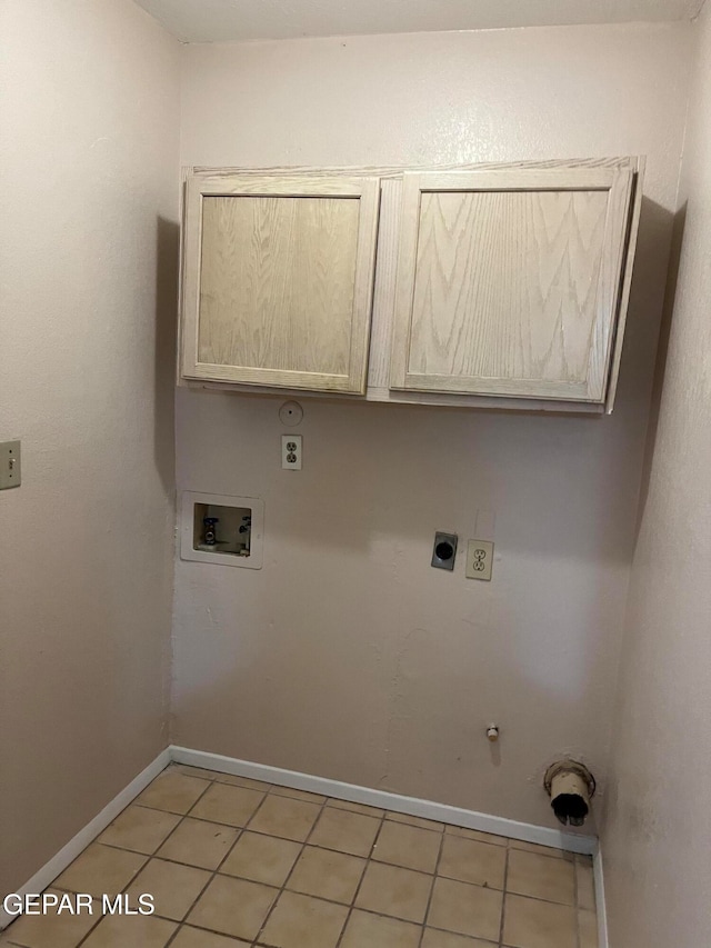 laundry area with hookup for an electric dryer, cabinets, gas dryer hookup, light tile patterned flooring, and hookup for a washing machine