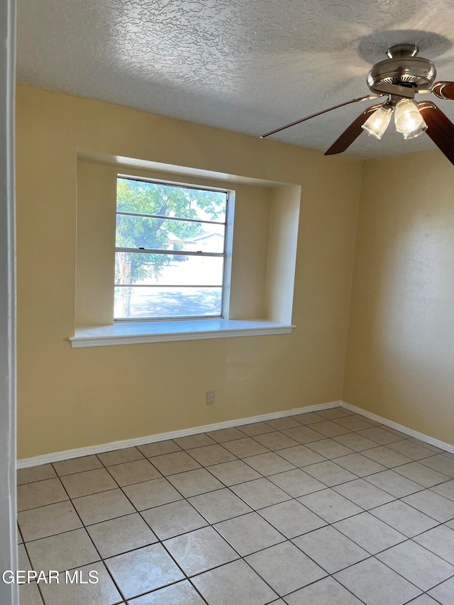 unfurnished room featuring a textured ceiling, light tile patterned floors, and ceiling fan