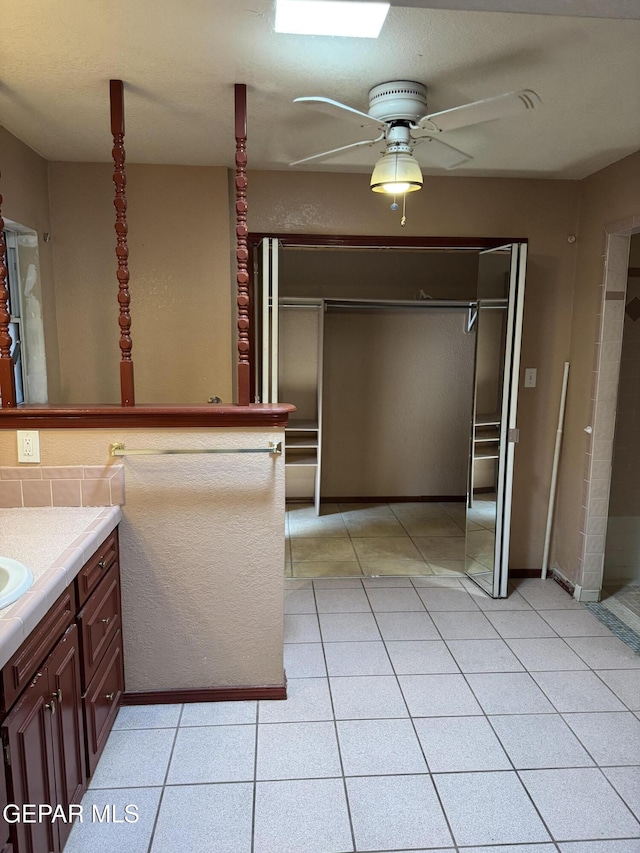 bathroom featuring ceiling fan, tile patterned flooring, and vanity