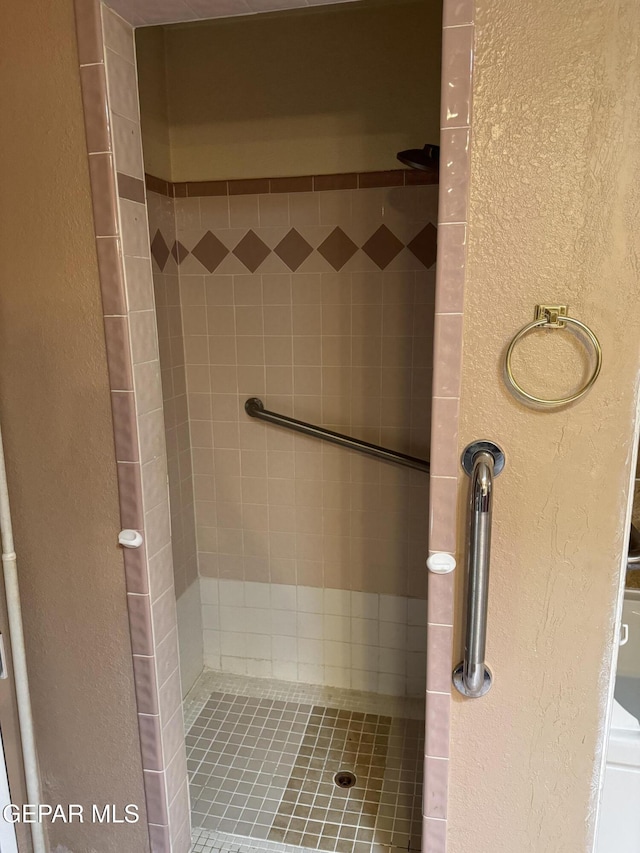 bathroom with tiled shower