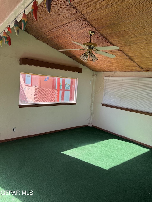 unfurnished room featuring ceiling fan, carpet floors, and vaulted ceiling