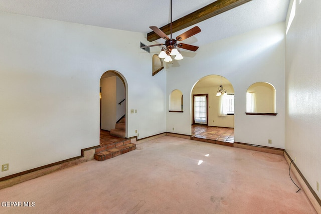 carpeted empty room featuring ceiling fan with notable chandelier, a textured ceiling, baseboard heating, high vaulted ceiling, and beam ceiling