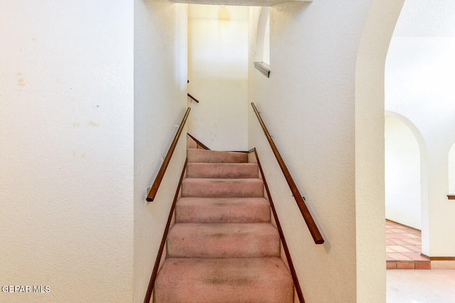 stairway with tile patterned floors