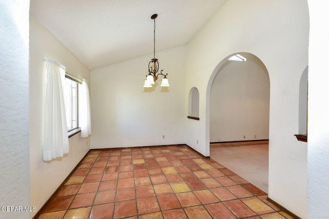 unfurnished room featuring high vaulted ceiling and a chandelier