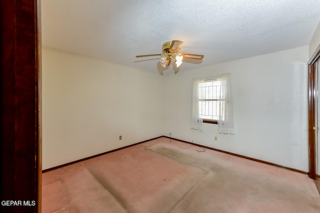 unfurnished room featuring ceiling fan, a textured ceiling, and light colored carpet