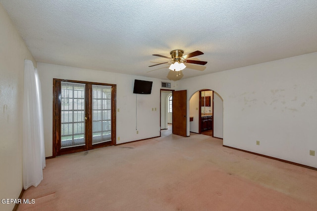 carpeted empty room with a textured ceiling and ceiling fan