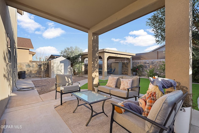 view of patio with an outdoor hangout area and a storage unit