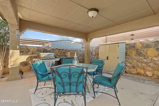 view of patio with a storage unit