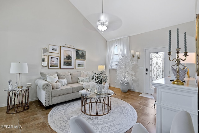 living room featuring ceiling fan and high vaulted ceiling