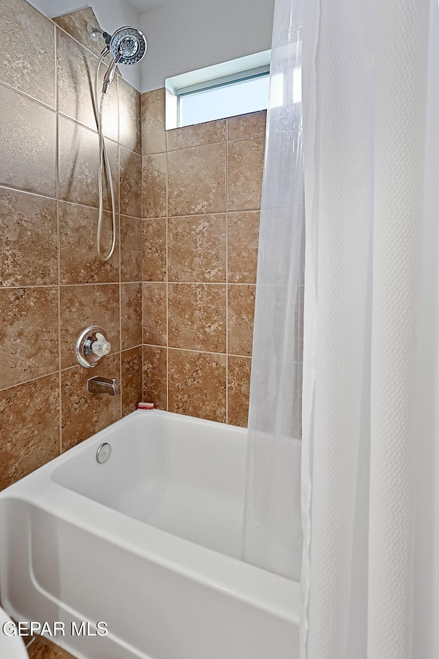 bathroom featuring shower / bath combination with curtain