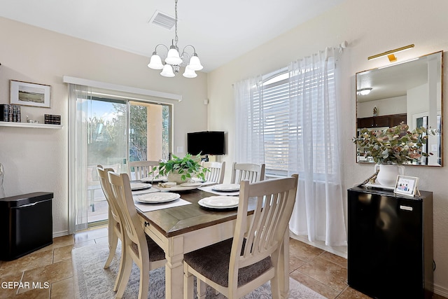 dining area featuring an inviting chandelier